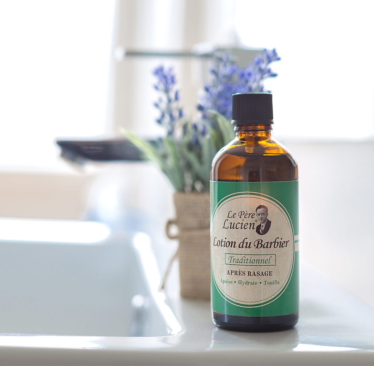 Lotion après-rasage Traditionnel Le Père Lucien, flacon de 100 ml dans une salle de bain